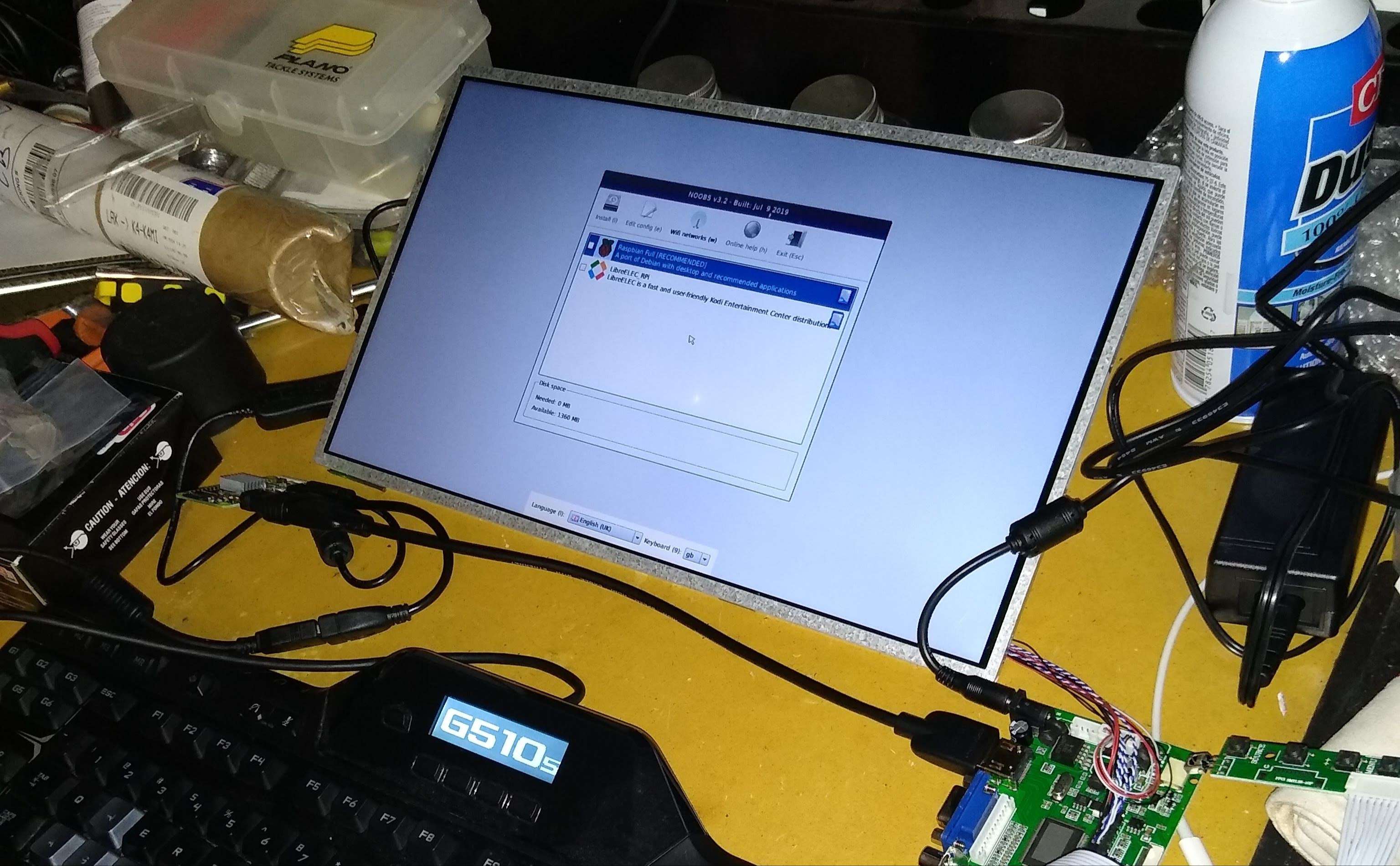 Image of an LCD screen plugged into a Raspberry Pi Zero W, with several cables and a keyboard connected.